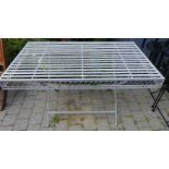 A grey painted metal strapwork X-frame garden table of rectangular form, length 130cm