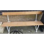 A white painted wrought iron ended and pine four seater waiting room bench, length 177cm