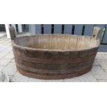 A coopered oak oval twin handled log bucket of good size, length 94cm