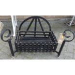 An early 20th century strapwork cast iron fire basket, with proud scroll front supports, width 73.