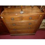 An early 20th century oak square front chest of two short over three long drawers (some