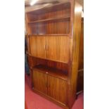 A 1970s Danish rosewood wall cabinet, having central and lower twin tambour sliding doors, one