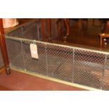 A late Victorian brass and pierced metal round cornered low nursery mesh fender, width 145cm,