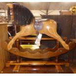 A contemporary layered plywood child's rocking horse by Ian Armstrong, raised on stained pine