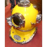 A contemporary chromed metal and yellow painted deep sea diver's helmet