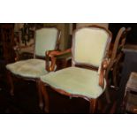 A pair of French beech elbow chairs with padded backs and stuff over seats, width 55cm