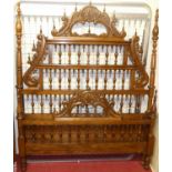 A Spanish elm double bedstead, the head and footboard with raised floral stylised and further ring