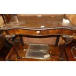 An early 20th century mahogany and flame mahogany serpentine side table having gadrooned edge and on