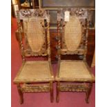 A pair of floral carved and pierced walnut cane back and seat dining chairs, in the 17th century