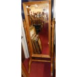 A modern pine cheval mirror, raised on bamboo effect frame