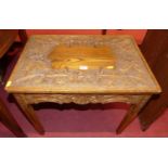 A floral relief carved oak low occasional table, width 56cm