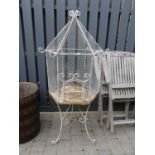 An early 20th century painted wrought iron, wired metal and hexagonal freestanding birdcage with