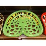 A pierced and cast iron tractor seat titled John Wallace & Sons, Glasgow, 18CR, painted in green and