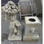 A reconstituted stone garden figural statue of a cherub holding a dove and a basket of fruit on