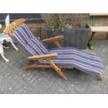A contemporary slatted teak folding steamer chair with cushion, width 57cm