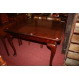 A mahogany round cornered extending dining table with single extra leaf on cabriole supports, max