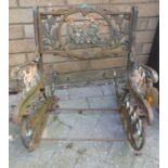 An early 20th century pierced wrought iron child's rocking garden chair (lacking slatted seat),