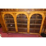 A 1930s walnut and figured walnut three door glazed bookcase, width 155cm