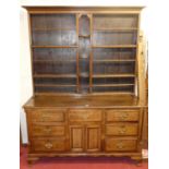 An 18th century and later constructed dresser with tiered open plate rack over base fitted with