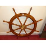 A contemporary teak and polished brass ship's wheel, max dia 106cm