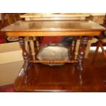 A Victorian walnut round cornered hall table, raised on turned end columns to floral carved hipped