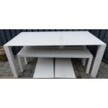 A contemporary white laminate finished extending dining table having two extra leaves, together with