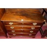 A 19th century mahogany low chest having four long graduated drawers, pinched corners, brass batwing