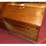 An early 19th century mahogany slopefront writing bureau, having fitted interior with gilt tooled