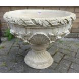 A contemporary reconstituted stone floral decorated circular pedestal footed squat planter, height