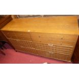 A 1960s light elm sideboard having twin upper drawers over four further grid decorated lower