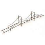 A very well made 0 Gauge suspension bridge, with metal legs supports and wooden blocks as feet,