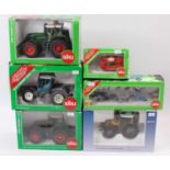 A collection of boxed Siku and Schuco model tractors and farming implements, with examples including