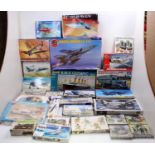 A large collection (two trays) of mixed plastic aircraft and military themed model kits to include a