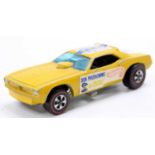 A Hot Wheels Redlines Plymouth Hot Rod as driven by Don Prudhomme with a yellow body, some play wear