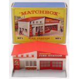 A Matchbox Lesney Accessory MF-1 Fire Station with a red roof and red brick labels, an excellent