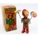 An Alps Toys of Japan tinplate and mechanical model of a Juggling Monkey comprising of soft