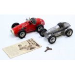 A collection of Schuco tinplate and clockwork Grand Prix style race cars to include a No. 1070