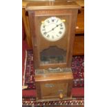 An early 20th century oak clocking-in and clocking-out time recorder by Stockall Marples & Co of