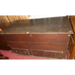 An 18th century oak hinged top mule chest, having twin lower drawers (lacking supports), w.136cm