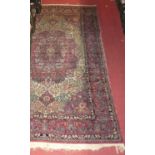 A Persian woollen red ground Tabriz rug, with a heavy floral trailing ground, 194 x 128cm