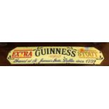 An enamel on metal advertising sign for Guinness Extra Stout, 12.5 x 57cm