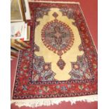 A Persian woollen cream ground Shiraz rug, having oval central medallion within conforming deep