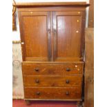 A Victorian scrumble finished pine linen cupboard, the twin panelled upper doors enclosing shelved