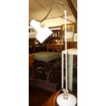 A contemporary white painted metal floor lamp, with adjustable branch arm
