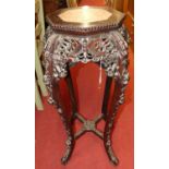 A Chinese carved rosewood jardiniere stand, of octagonal baluster form, with marble inset top and