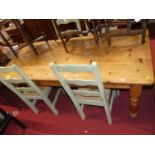 A pine round cornered farmhouse kitchen table, raised on turned supports, length 182cm, together