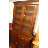 An Edwardian walnut bookcase cupboard, having twin glazed upper doors, width 122.5cm