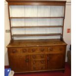 A circa 1800 provincial joined oak dresser, having three-tier open plate rack over base fitted