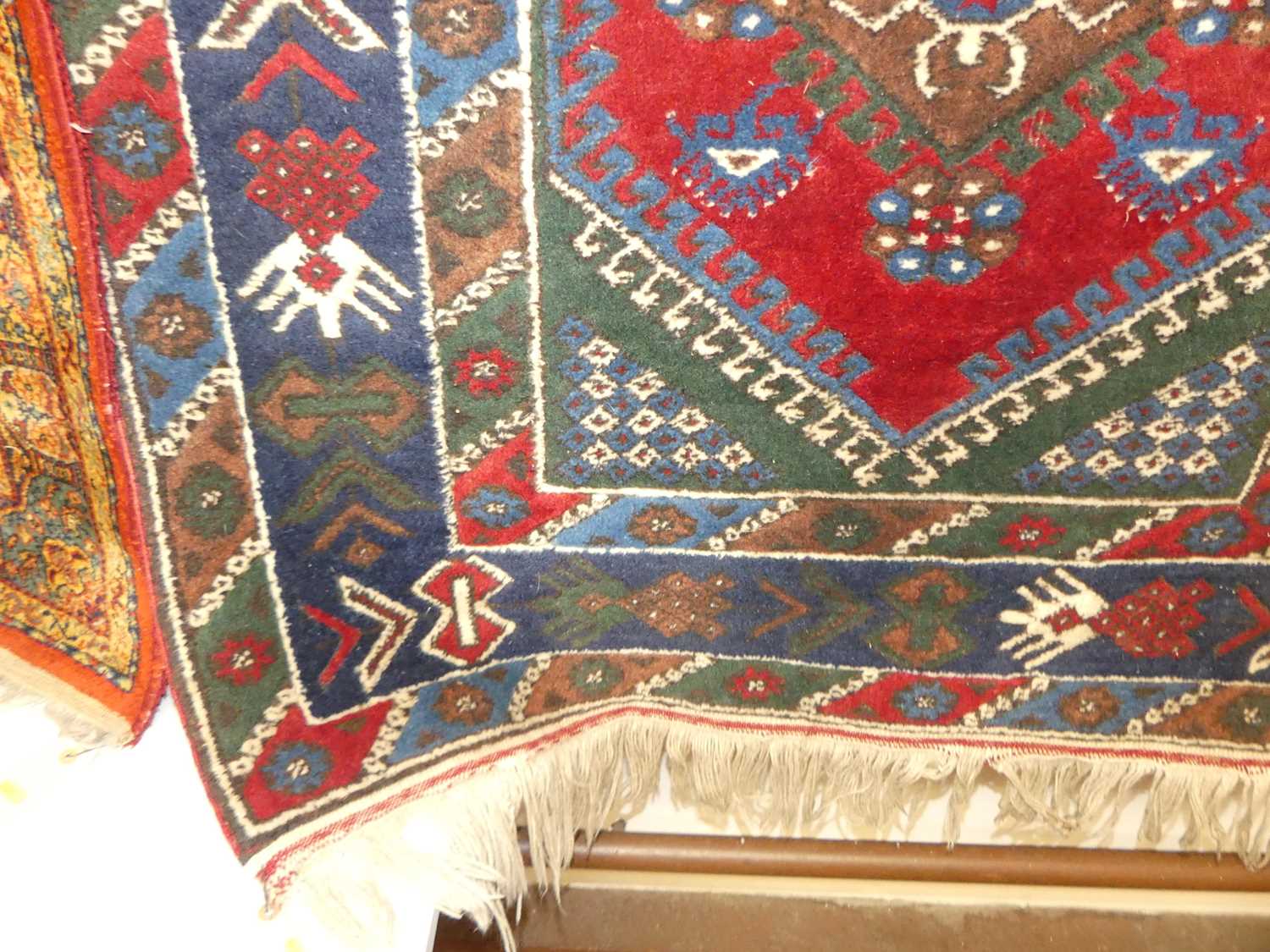 A Turkish woollen red and blue ground rug, the lozenge central field within conforming trailing - Image 2 of 3