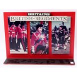 An original Britains British Regiments 1980s shop display stand, comprising of red moulded plastic